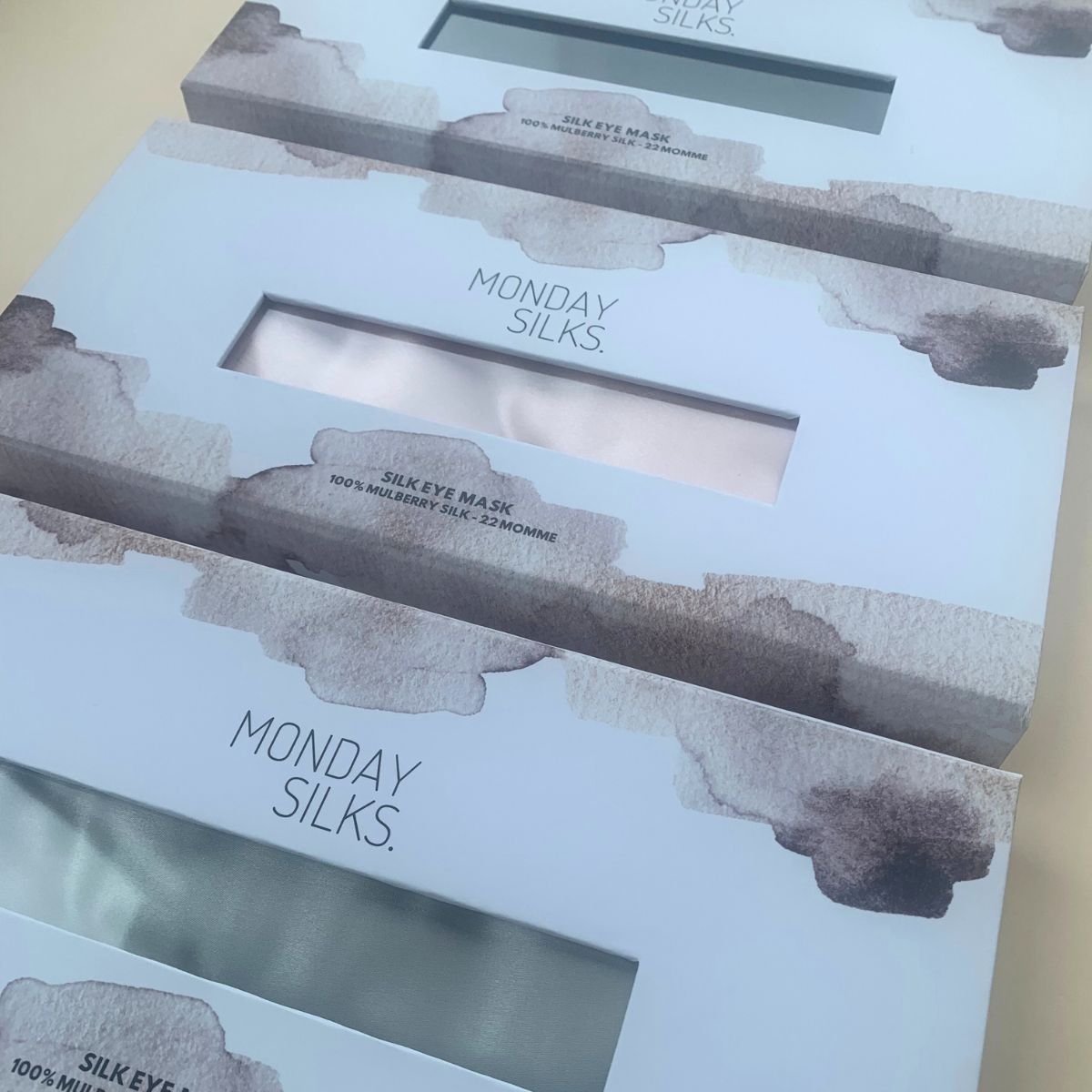 Monday Silks silk eye mask in multiple colors. Elegant boxes showcasing luxury sleep masks made from pure silk.