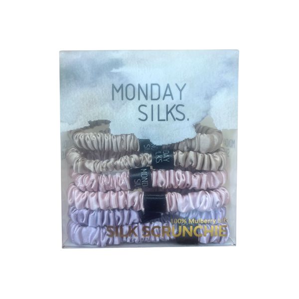 Pack of silk scrunchies with 'Monday Silks' branding on a light blue background